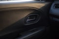 Inner car door handle of a compact modern car, view from an interior of a back seat. Royalty Free Stock Photo