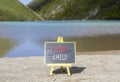 Inner child symbol. Concept words Inner child on beautiful black chalk blackboard. Beautiful mountain lake background.