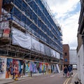 Inner City Construction Site Development Surrounded By Scaffolding With Saferty Netting And Painted Security Fencing Royalty Free Stock Photo