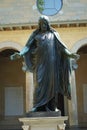 The inner courtyard of the ancient Friedenskirche church with old statue of Jesus Christ with open arms in Sanssouci Park