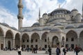 Inner courtyard of the Blue Mosque in Istanbul. Visitors, tourists and believers Royalty Free Stock Photo