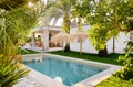 Inner garden with private swimming pool straw parasol beautiful luxury wealthy residential summer villa, sunny day, no people.