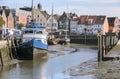 Inner harbor at low tide in the old town of Husum with boats on Royalty Free Stock Photo