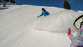 Innerkrems - Couple in skiing outfit sliding down the ski run of Innerkrems, Austria. The woman is taking a selfie. Royalty Free Stock Photo