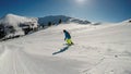 Innerkrems - A skiing man in blue and green outfit going down the ski run in Innerkrems, Austria. Everything is covered with snow Royalty Free Stock Photo