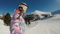 Innerkrems - A snowboarding woman in pink outfit taking a selfie while going down the slope in Innerkrems, Royalty Free Stock Photo