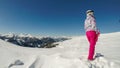 Innerkrems - A woman in pink skiing outfit and a white helmet enjoys the view in front of her while standing on the slopes Royalty Free Stock Photo