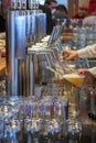 an innkeeper fills beer glasses at the bar