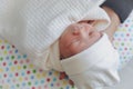 Innocence face of cute baby newborn close eye sleeping in white blanket Royalty Free Stock Photo