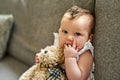 The innocence of an infant. Portrait of an adorable baby girl playing with a teddybear at home.