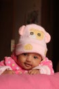 Innocent asian baby girl in pink winter cap Royalty Free Stock Photo