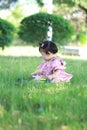 Innocent baby girl play a ball on the lawn Royalty Free Stock Photo