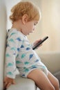 Innocent child playing music on a phone Royalty Free Stock Photo