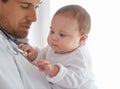 Innocent curiosity. a handsome male doctor holding a baby. Royalty Free Stock Photo