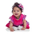 Innocent, cute and happy baby girl in a studio with a floral, beautiful and flower outfit and headband. Happiness, smile Royalty Free Stock Photo