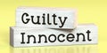 Innocent, guilty - words on wooden blocks