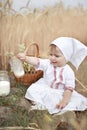 An innocent happy cute baby holds a glass of fresh cow`s milk Royalty Free Stock Photo