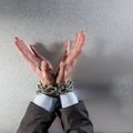 Innocent professional man hands tied with chain for suspicious management Royalty Free Stock Photo