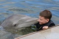 Innocent Young Boy with a Dolphin Royalty Free Stock Photo