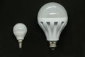 The innovation is a candle and new economical light bulbs on a black background