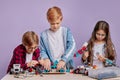 Portrait of three caucasian children interested in futurustic toys