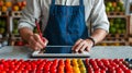 Innovative fruit vendor using a digital tablet for inventory management and online order processing