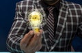 Innovative idea concept shown by businessman holding bulb in hand