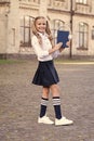 Innovative lifelong learning. using headset technology. small happy girl listen e-book. pupil in retro uniform listen Royalty Free Stock Photo