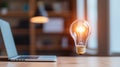 Innovative light bulb floating above laptop in modern workspace symbolizing creativity and data analytics warm glow adds touch Royalty Free Stock Photo