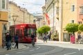 Innsbruck, Austria - April 17th 2018: A red coloured tram passing the historic buildings at Marktgraben