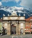 Innsbruck, Austria - April 17th 2018: View of the historic Triumphpforte with alpine peaks in the background.