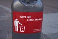 Innsbruck, Austria - March 20.2019: Trash Can in interesting Design in Austria, text: Give me some more, Series of red signs on