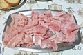 Platter with mortadella and `cotto` ham on a table