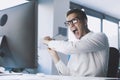 Insane angry businessman hitting the computer with the keyboard Royalty Free Stock Photo