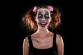 Insane female clown in front of black