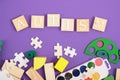 Inscription autism on wooden squares, purple background, copy space, developmental toys and paints for training and diagnosis Royalty Free Stock Photo