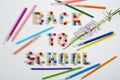 Inscription Back To School made of number beads. Decorated by flower and colourful pencils. Royalty Free Stock Photo