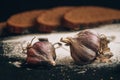 Inscription bakery on white wheat flour scattered Sliced rye bread with garlic on dark background