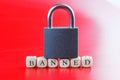 Inscription banned with closed padlock on it. Red and white background. Concept of banned internet forum, chat room, website,