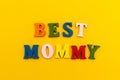 The inscription `Best Mommy` in colorful letters on a yellow background.