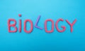 Inscription biology in red letters on a blue background, evolution science concept