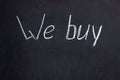 The inscription on the chalkboard `We buy`