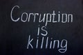 The inscription on the chalkboard Corruption is killing Royalty Free Stock Photo