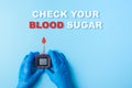 Inscription check your blood sugar and Nurse making a blood test with red blood drop and Glucose meter Royalty Free Stock Photo