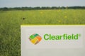 Inscription on the Clearfield sign, against the background of the canola field. The insect is flyin