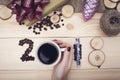 2018 inscription of coffee beans, woman's hand holding a coffee mug and wooden slices, purple christmas toys
