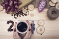 2018 inscription of coffee beans, woman's hands holding a coffee mug and wooden slices, purple christmas toys