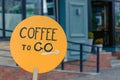 Inscription coffee to go on an orange wooden plank. coffee shop, cafe advertisement