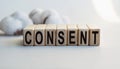 The inscription CONSENT on wooden cubes isolated on a light background. Concept word forming on wooden cube. Business, economics