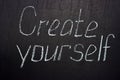 Inscription on a dark board Create yourself